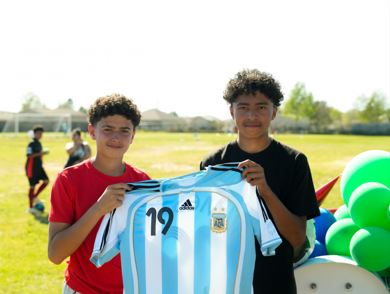 Boys holding Messi's Jersey
