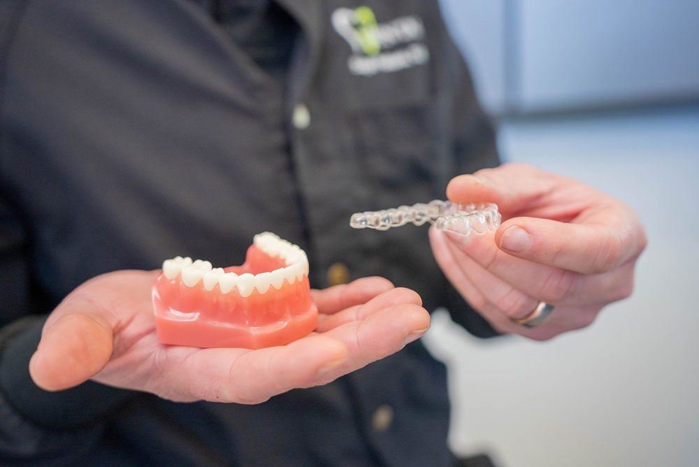 Doctor holding dental model with Invisalign